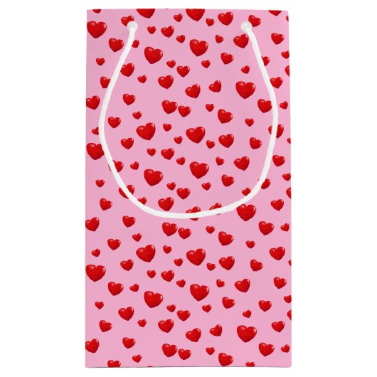 Verspreide rode harten op roze klein cadeauzakje (Achterkant)