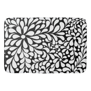 Vette moderne witte bloemen op zwarte achtergrond badmat