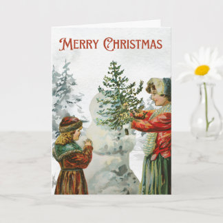 Victoriaans meisjes bouwen een sneeuwpop kaart