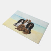 Vier Cavalier King Charles Spaniels op het strand Deurmat (Schuin)
