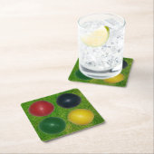 Vier croquet ballen, vier kleuren, gras achtergron kartonnen onderzetters (Insitu)