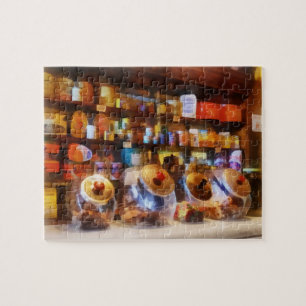 Vier glazen potten met snoep legpuzzel