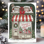 Vintage Christmas Storefront Holiday Kaart<br><div class="desc">Stuur nostalgische feestgroeten met deze prachtig geïllustreerde vintage kerstkaart. Het ontwerp is voorzien van een charmante winkel versierd met feestelijke decoraties, waaronder een rood en wit gestreepte luifel, kransen, twinkelende lichten en netjes verpakte geschenken weergegeven in het raam. Een gezellige met sneeuw bedekte scène, perfect voor het verspreiden van warmte...</div>