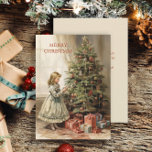 Vintage kerstboom meisje geschenken feestdagenkaart<br><div class="desc">Kerst wenskaart met een schilderij van een meisje versieren van een kerstboom met ingepakte geschenken eronder. Tekst zegt, "Vrolijk kerstfeest" maar is aanpasbaar voor uw eigen begroeting. Gepersonaliseerd op de achterkant met uw bericht en naam. Neem contact met mij op voor hulp bij uw maatwerk of om extra matching of...</div>