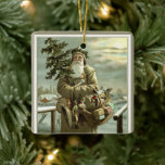 Vintage Kerstmis, Victoriaans kerstman met speelgo Keramisch Ornament<br><div class="desc">illustratie kerstvakantieontwerp met een Victoriaans kerstman die door de sneeuw loopt en de voetafdrukken verlaat. Hij draagt een kerstboom en een mandje speelgoed op een troebele avond met de maan die door de wolken schittert. Oorspronkelijk een Scandinavisch briefkaart met de tekst: God jul of vrolijk kerstfeest.</div>