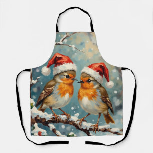 Vintage roodborstjes met kerstmutsen op besneeuwde schort