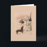 Vintage - Snowman Greets a Dachshund Feestdagen Kaart<br><div class="desc">Een  illustratie van een sneeuwman die zijn bovenste hoed aan het dopen is en zijn hoofd in groet houdt met een Dachshund-hond die hem benaderd heeft op een sneeuwwinterdag.  Deze kaart is leeg binnenin voor je eigen bericht.</div>
