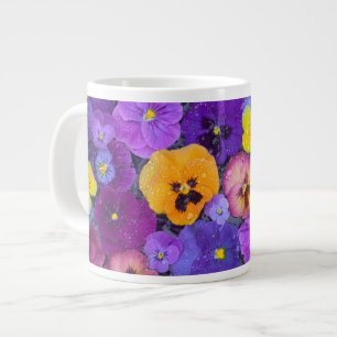 Viola bloemen drijvend in vogelbad met dauw grote koffiekop