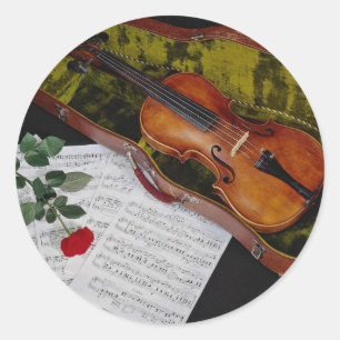 Violin en rode roos op zwarte achtergrond ronde sticker