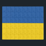 Vlag van Button Oekraïne Puzzel<br><div class="desc">De vlag van Oekraïne is een spandoek van twee even grote horizontale banden van blauw en geel. Bovenaan staat de hemel en de geel staat voor tarwe. De nationale vlag van Oekraïne</div>