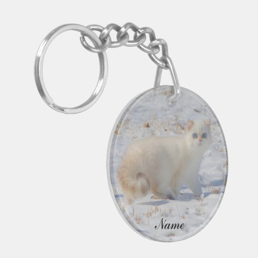 Vlampunts met blauwe ogen in de sneeuw sleutelhanger (Voorkant Links)