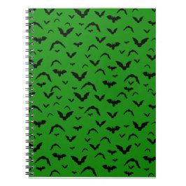 Vliegende vleermuizen op groen notitieboek