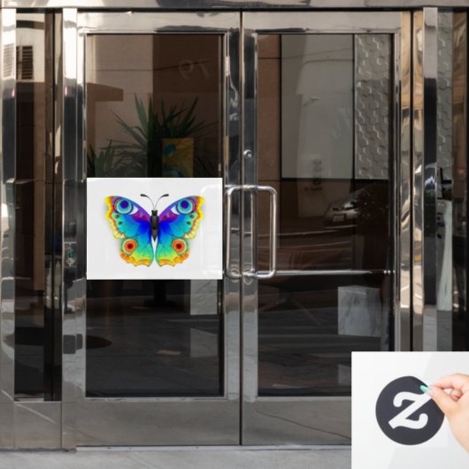 Vlinder met pauwenogen in regenboogkleuren raamsticker (Kantoordeur)