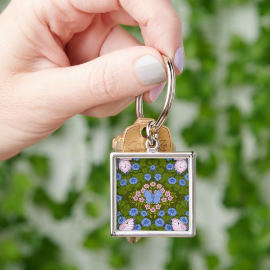 Vlinders en bloemen symmetrie, blauw en roze sleutelhanger (Hand)