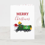 Vrachtwagen voor kerstrecycling van vuilnis feestdagen kaart<br><div class="desc">Een schattige illustratie van een vuilniswagen met kerstrecycleerbaarheid met een kersthoed en versierd in kerstverlichting met de woorden "Vrolijk kerstfeest". Een ideaal kerstkaartontwerp voor vuilnismannen,  grote of kleine meisjes of jongens.</div>