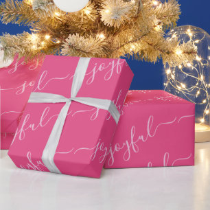 Vreugdevolle scrolltekst in roze kerst cadeaupapier