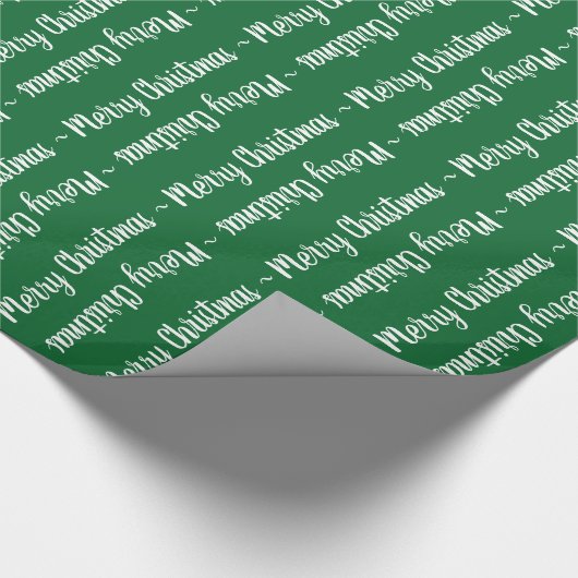 Vroege kersttypografie in het wit op groen cadeau cadeaupapier (Hoek)