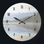 Vroege ochtend reflecteert het landschap grote klok<br><div class="desc">Een kalm landschap met een kalm en sereen meer met een lichte mist op het oppervlak. Een bos van groene bomen beugt de kust. Misty bergen stijgen op de achtergrond. De wolken boven zien er uit als zachte zachte waterverven en de hele scène wordt prachtig weergegeven in het stille meer....</div>