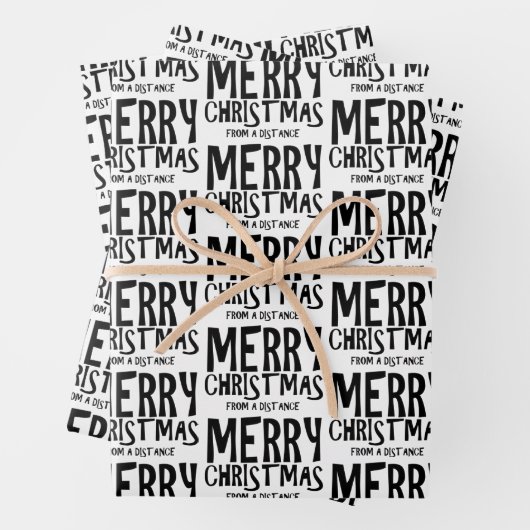 Vrolijk kerstfeest vanaf een verafgelegen pakpapie inpakpapier vel (In situ)