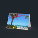 Vrolijk kerstfeest vanuit Vero Beach Florida Ocean Feestdagen Kaart<br><div class="desc">Vrolijk kerstfeest uit Vero Beach, Florida! Dit kleurrijke tropische wenskaart is voorzien van een foto-afbeelding van een prachtig gebied rond de oceanfront van Vero Beach, dat allemaal voor de feestdagen is afgedekt. Het feestelijke ontwerp omvat kerstlichten op het groen, kerstballen die aan een palmschijfje hangen, en de tekst "Vrolijk kerstfeest"...</div>