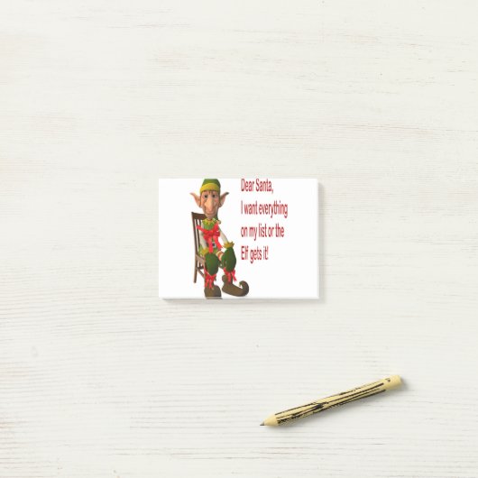 Vrolijk kerstfeest voor iedereen. elf gehouden voo post-it® notes (Op bureau)