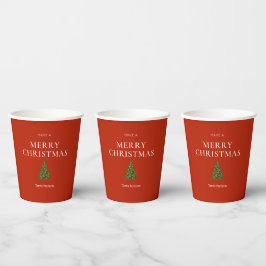 Vrolijke kerstgroet met boom op rood gebruik papieren bekers