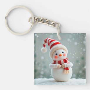 Vrolijke sneeuwmanfiguur met feesthoed sleutelhanger