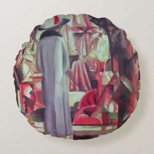 Vrouw voor een groot verlicht raam rond kussen