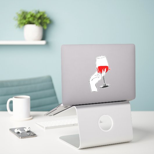 Vrouwen hand houden wijnglas kunst sticker (Laptop op bureau)