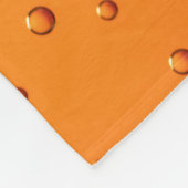 Waterdruppels op oranje oppervlak fleece deken (Hoek)