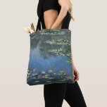 Waterlioenen van Claude Monet,  bloemen Tote Bag<br><div class="desc">Prachtige canvas tassen die overdreven zijn! Beschikbaar in twee stijlen en twee grootten! Water Lilies (1906) van Claude Monet is een impressionisme in het kunstlandschap schilderij. Het is een van de vele variaties van waterlelie schilderijen die Monet schilderde in zijn bloemtuin in Giverny, Frankrijk. Waterlelijke bloemen in een veerseizoen vijver....</div>