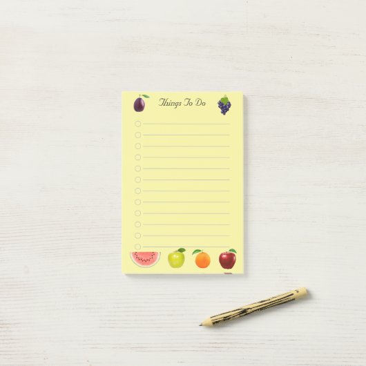 Watermeloen appel- en druiventeelt op geel papier post-it® notes (Op bureau)