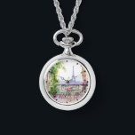 Waterverf Eiffeltoren Parijs Frans Café Horloge<br><div class="desc">Waterverf Eiffeltoren Paris French Cafe Watch Ketting beschikt over een waterverf Franse café zithoek met Paris en de Eiffeltoren op de achtergrond. Creëer door Evco Studio www.zazzle.com/store/evcostudio</div>