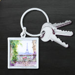Waterverf Eiffeltoren Parijs Frans Café Sleutelhanger<br><div class="desc">Waterverf Eiffeltoren Paris French Cafe Sleutelhanger beschikt over een waterverf Franse café zithoek met Paris en de Eiffeltoren op de achtergrond. Creëer door Evco Studio www.zazzle.com/store/evcostudio</div>