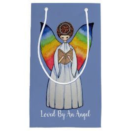 Waterverf engel met regenboogvleugels die een boek klein cadeauzakje