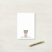 Waterverf engel met regenboogvleugels die een boek post-it® notes (Op bureau)