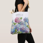 Wedding Blue Hydrangea Floral Bridesmaid Tote Bag<br><div class="desc">Deze elegante bruidachtige canvas tas is voorzien van prachtige blauwe en luidere hydrangebloemen. Bovenaan staat een naam en titel van bruidsmeisje die gepersonaliseerd kan worden. Ontworpen door een wereldberoemde kunstenaar ©Tim Coffey.</div>