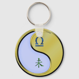 Weegschaal en metalen geit sleutelhanger