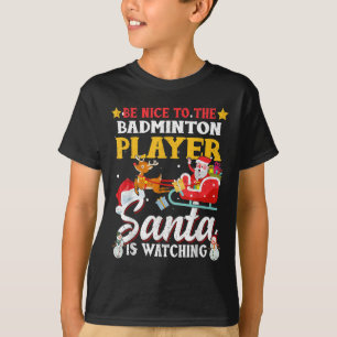 Wees aardig voor badmintonspeler Santa kijkt naar T-shirt