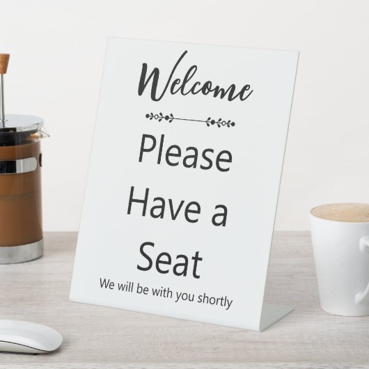 Welcome Please Have a Seat White and Black Reclamebord Met Voetstuk (Insitu)