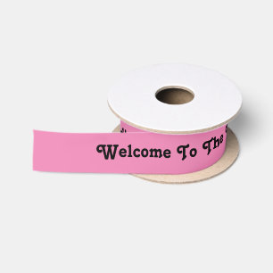 Welkom in de wereld, lint in roze en zwart.