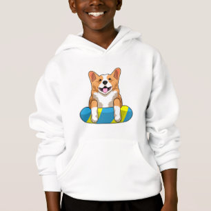 Welsh Corgi tijdens het zwemmen met een zwembord