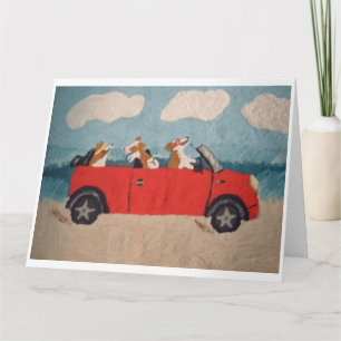 Welshe Corgi's in een rode cabriolet op het strand Kaart