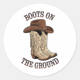 Westerne cowboylaarzen op de grond dansen op ronde sticker
