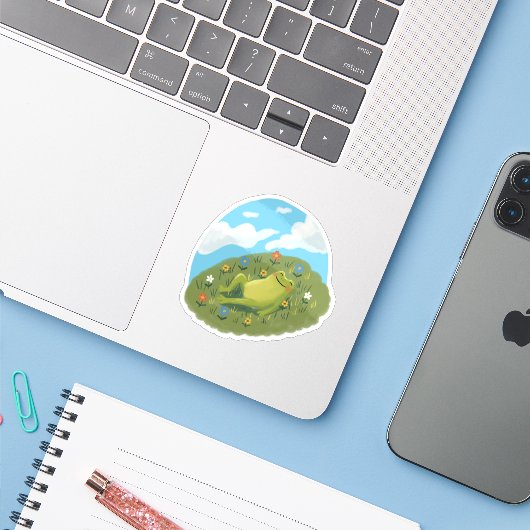 Whimsical Frog Chilling On The Hill Illustration Sticker (Laptop met iPhone)
