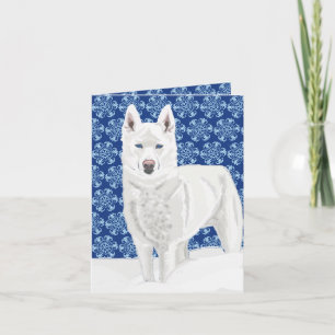 White Husky tegen sneeuwvlokken en donkerblauwe he Kaart