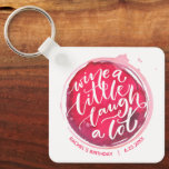 Wijn een kleine Sleutelhanger<br><div class="desc">Ronde sleutelhanger bevat een leuke tekst "Wine a Little Laugh A Lot" op een rode wijnvlek,  die is gepersonaliseerd met alle informatie. Sleutelhangers maken gedenkwaardige cadeaus voor familie en vrienden of voor jezelf creëer.</div>