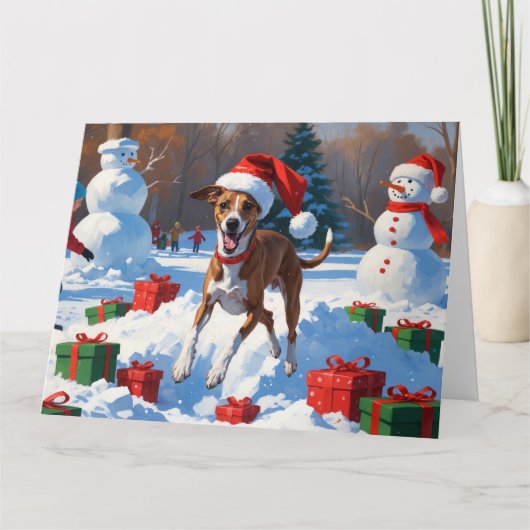 Windhond hardlopen in de sneeuw met kerst Pet Kaart (Voorkant)
