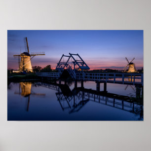 Windmolens en een brug bij zonsondergang poster