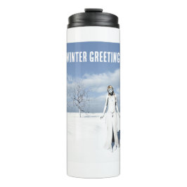 Winter Greetings. Female elf walking in the snow  Thermosbeker